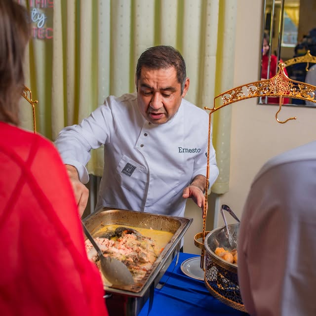 Chef Ernesto Leon serving a hot buffet at a Home Chef UK event in London