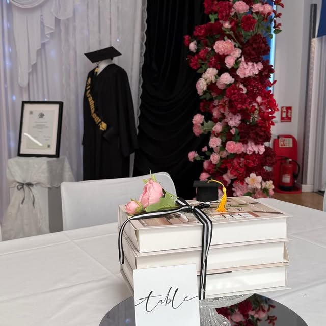 Graduation table styling with gown, florals and personalised details by Home Chef UK